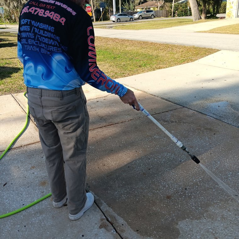 Lift Off's owner pressure washing in a company uniform